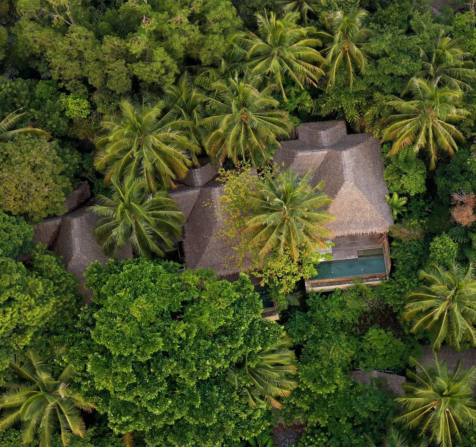 Aerial view of a private villa with pool